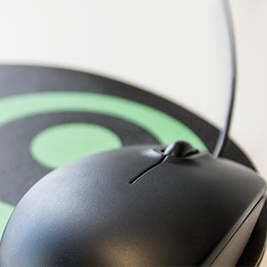 Computer mouse and mouse pad laying on a desk